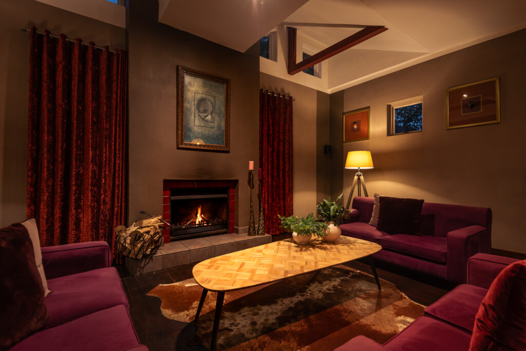 Lounge with fireplace at Lilypond Lodge